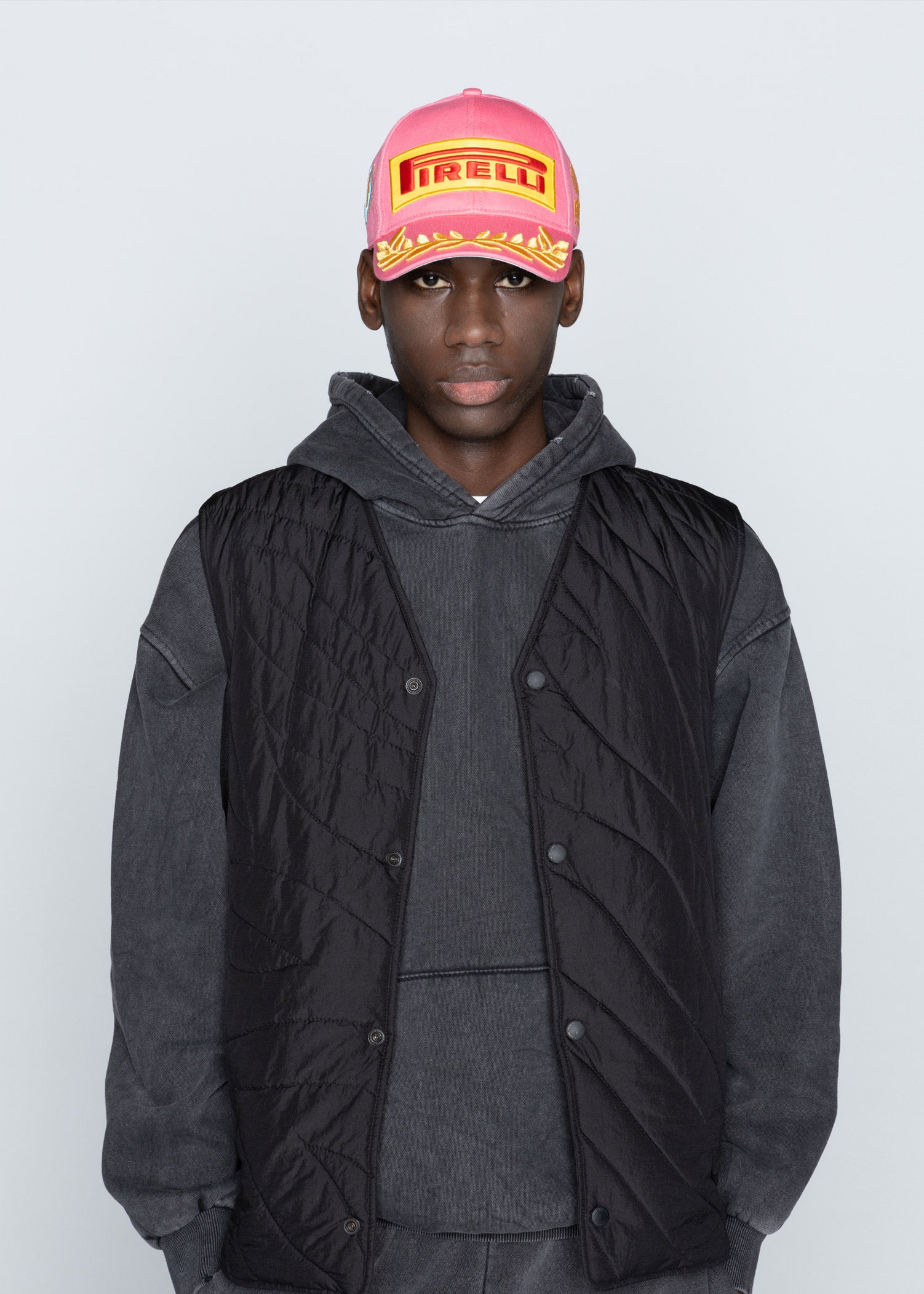 man in pink Pirelli Podium Cap
