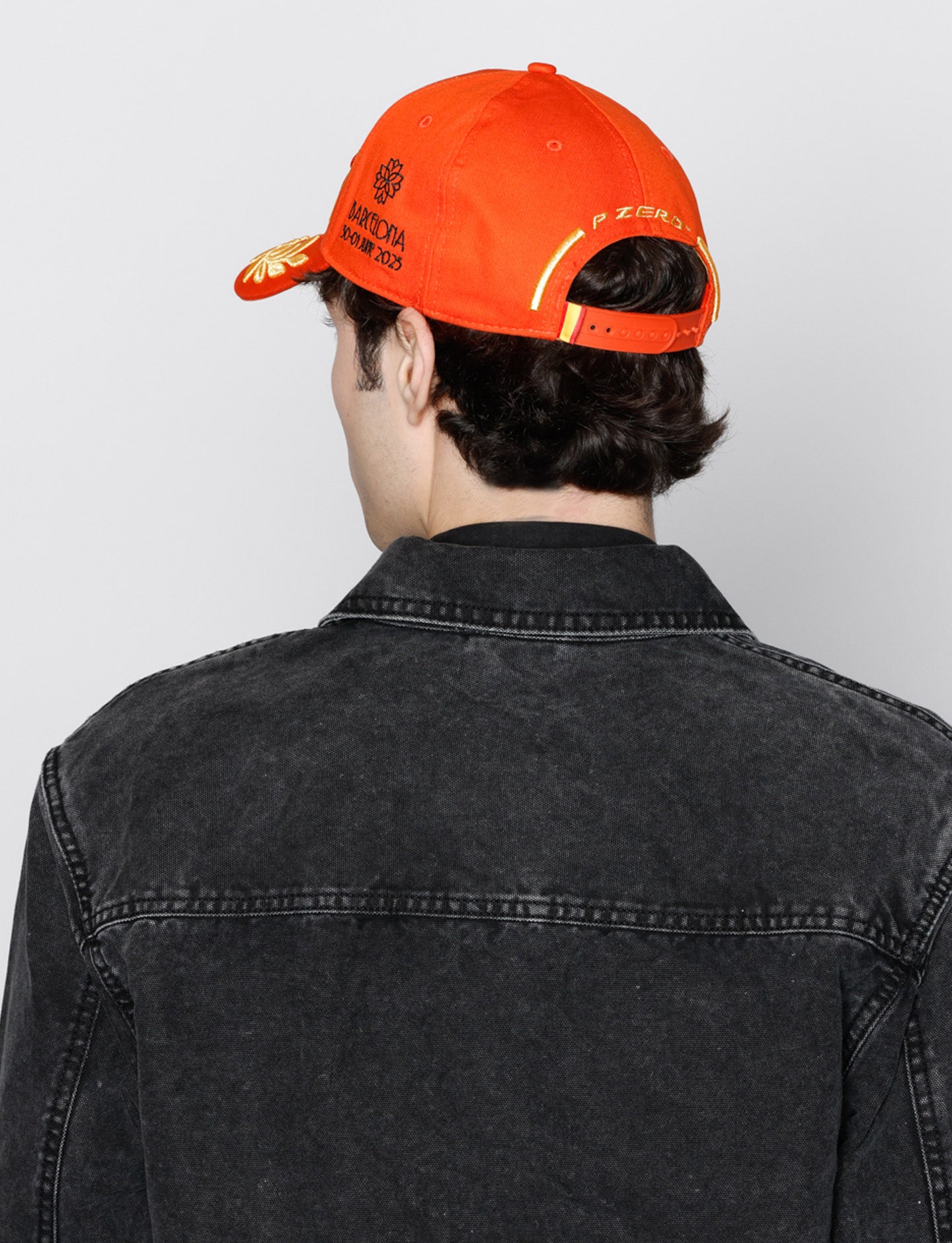 man in Orange Pirelli Podium Cap